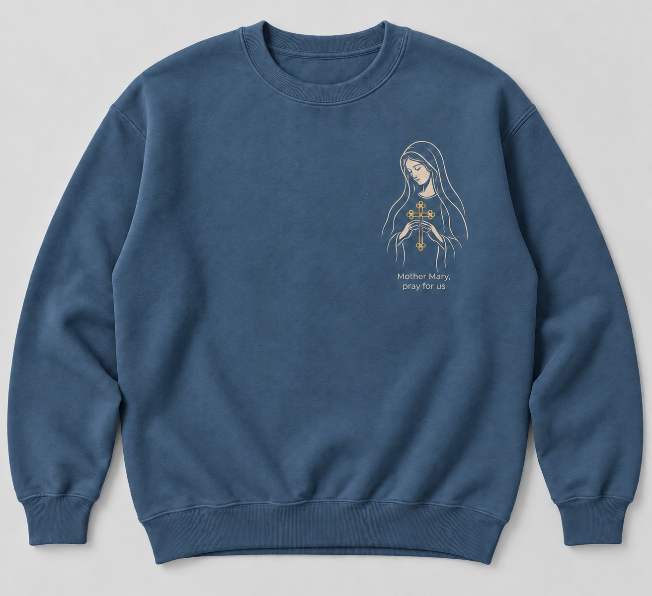 Indigo-blue concept crewneck sweatshirt with ivory Mother Mary linework holding a gold Chaldean cross and the words Mother Mary, pray for us
