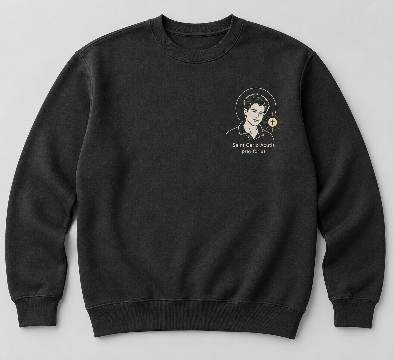 Charcoal crewneck sweatshirt with a small ivory portrait of Saint Carlo Acutis, a gold Eucharist detail, and the words Saint Carlo Acutis, pray for us